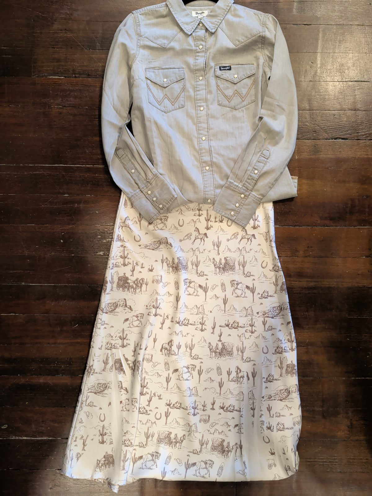 Wrangler grey denim Western snap shirt styled with a cream skirt featuring horses, cacti and Western motifs.