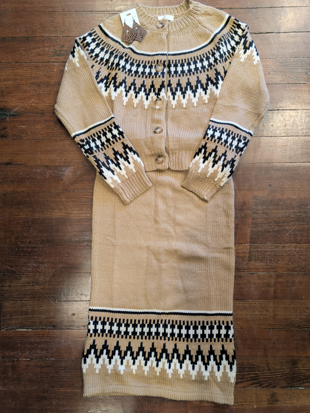 Light brown Fair Isle cardigan styled with a matching patterned knit skirt and brown teardrop earrings.