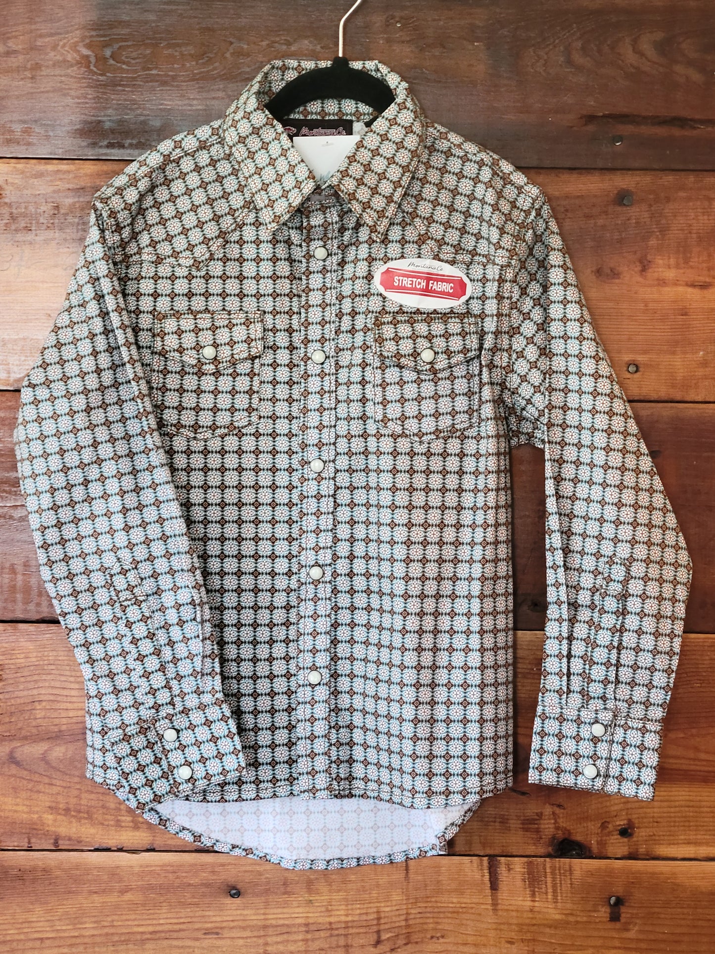 Plaid shirt with a label on a wooden background