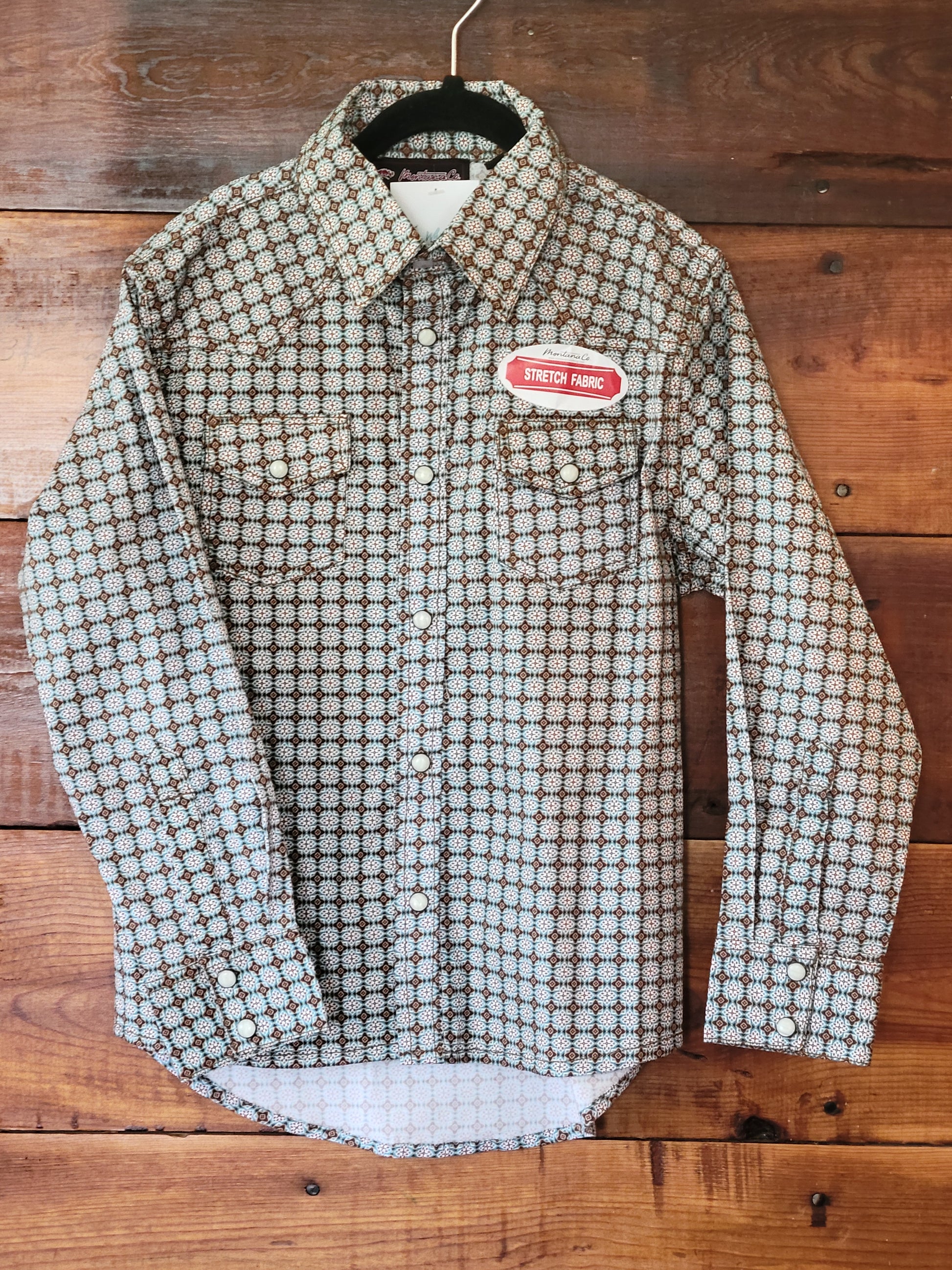 Plaid shirt with a label on a wooden background