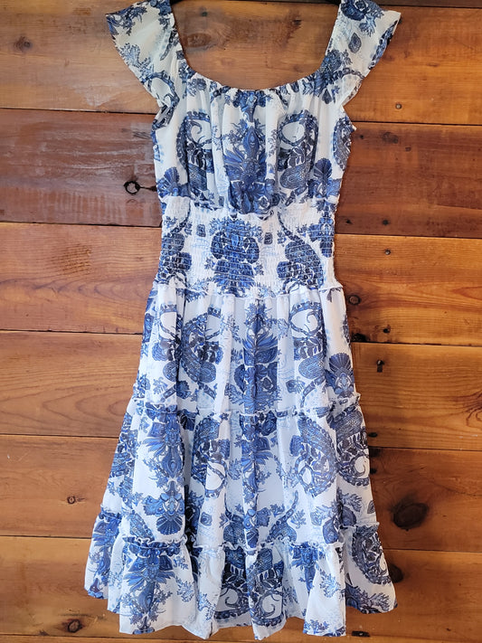 Blue and white floral dress on a wooden surface