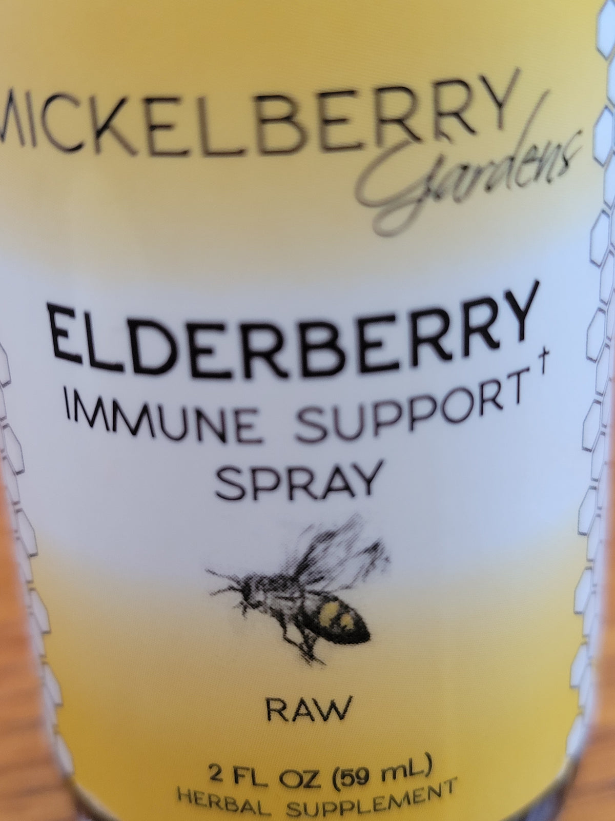 Close-up of Mickelberry Gardens Elderberry Immune Support Spray label showing the bee illustration and 2 fl. oz. size