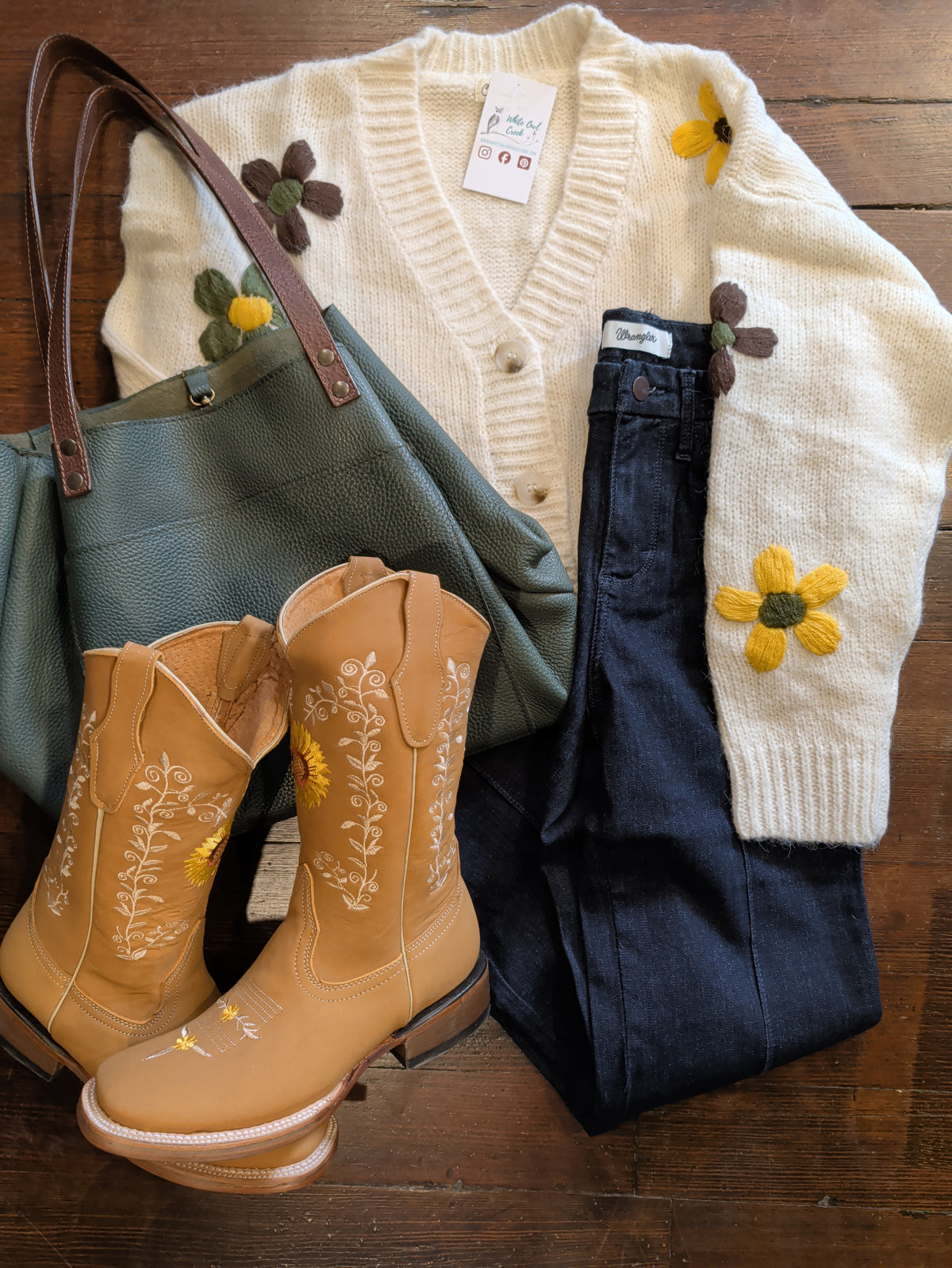 Wrangler Bespoke Camryn jeans with a cream floral cardigan, green tote and tan embroidered cowboy boots.