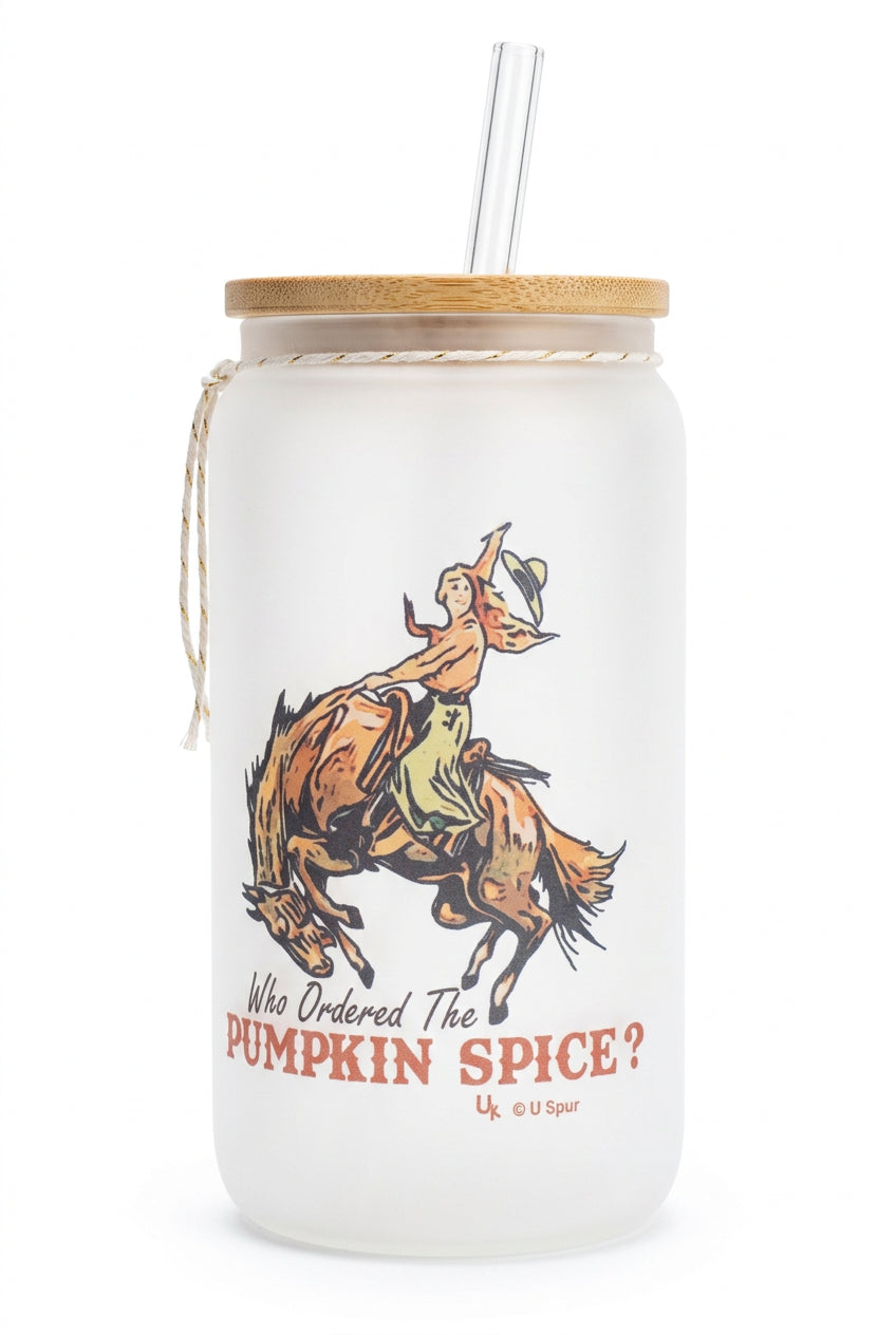 Frosted glass tumbler with a bronc rider illustration, pumpkin spice wording, a lid, and a clear straw