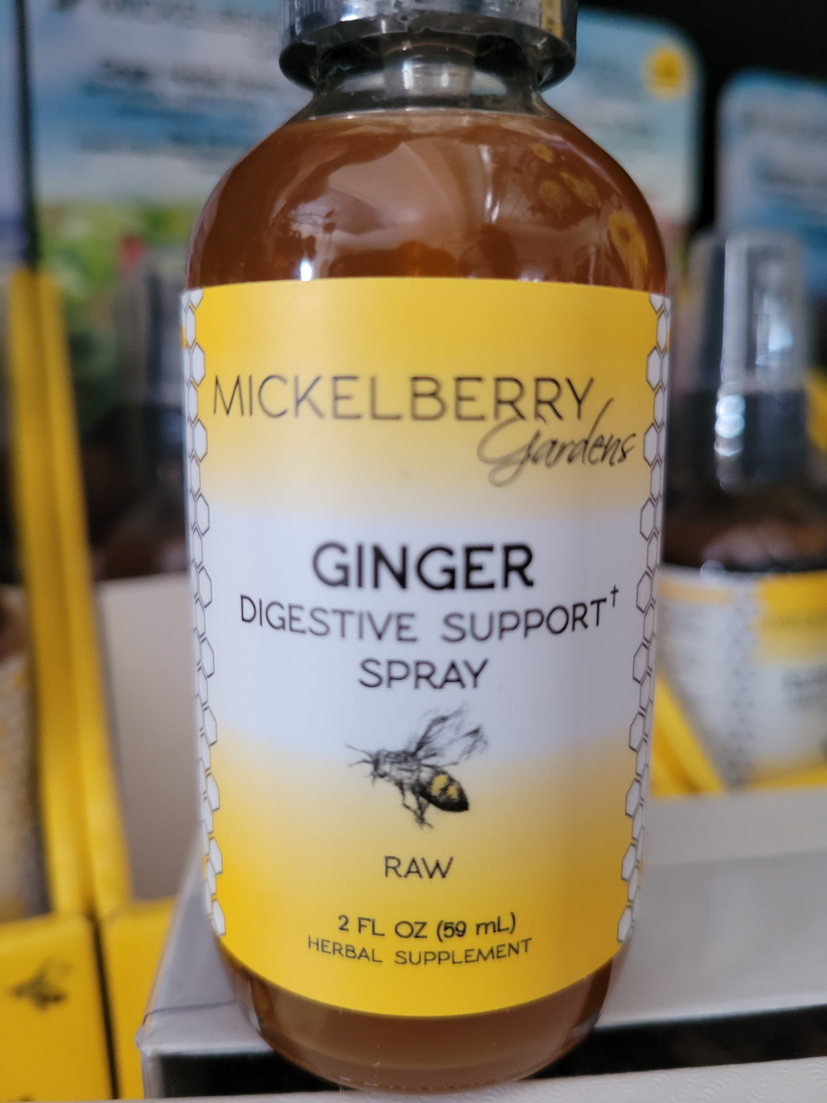 Mickelberry Gardens Ginger Digestive Support Spray 2 fl. oz. bottle with yellow label and bee illustration
