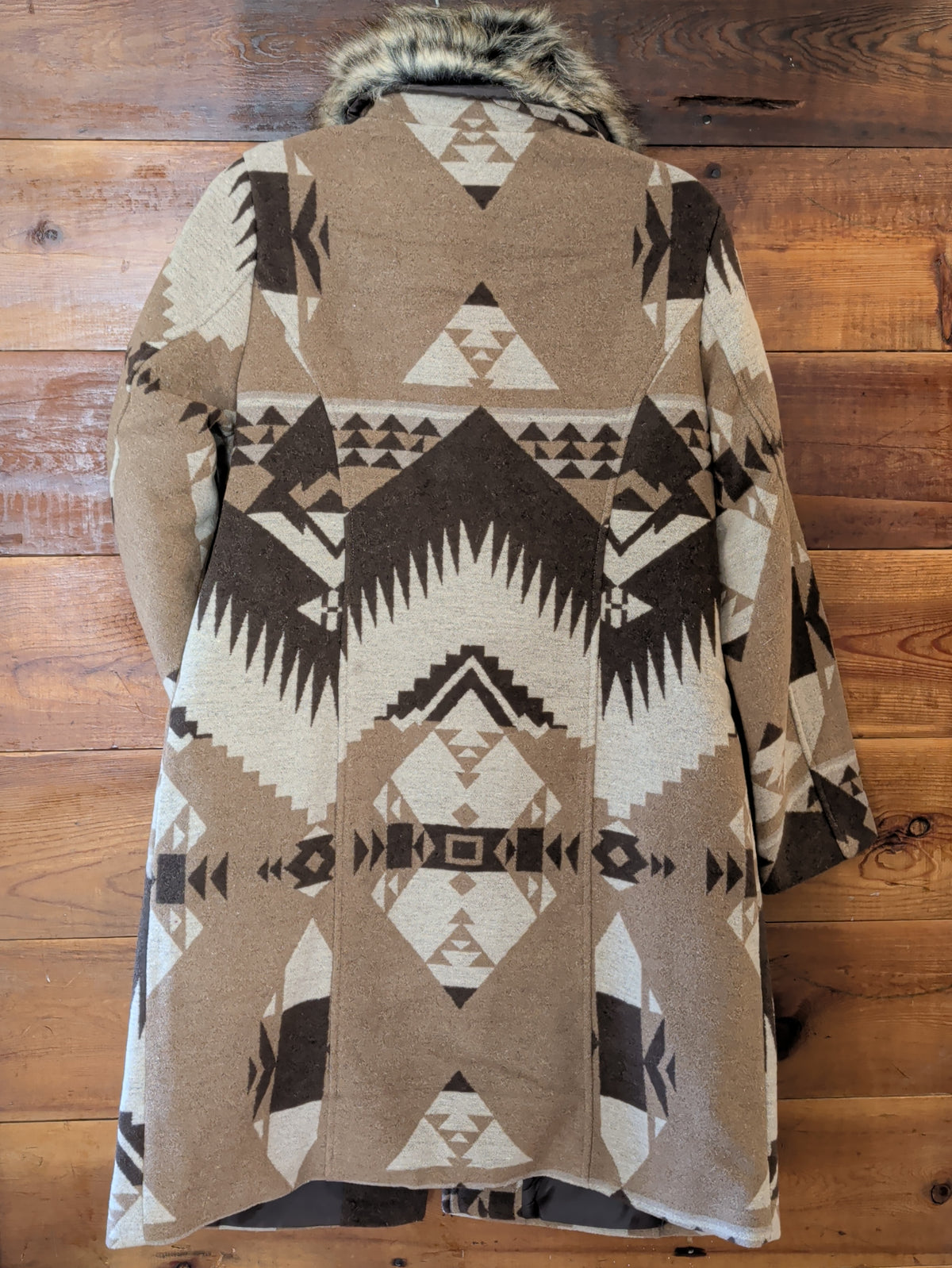 Back view of women's long coat showing the cream, taupe, and brown Southwestern geometric pattern.