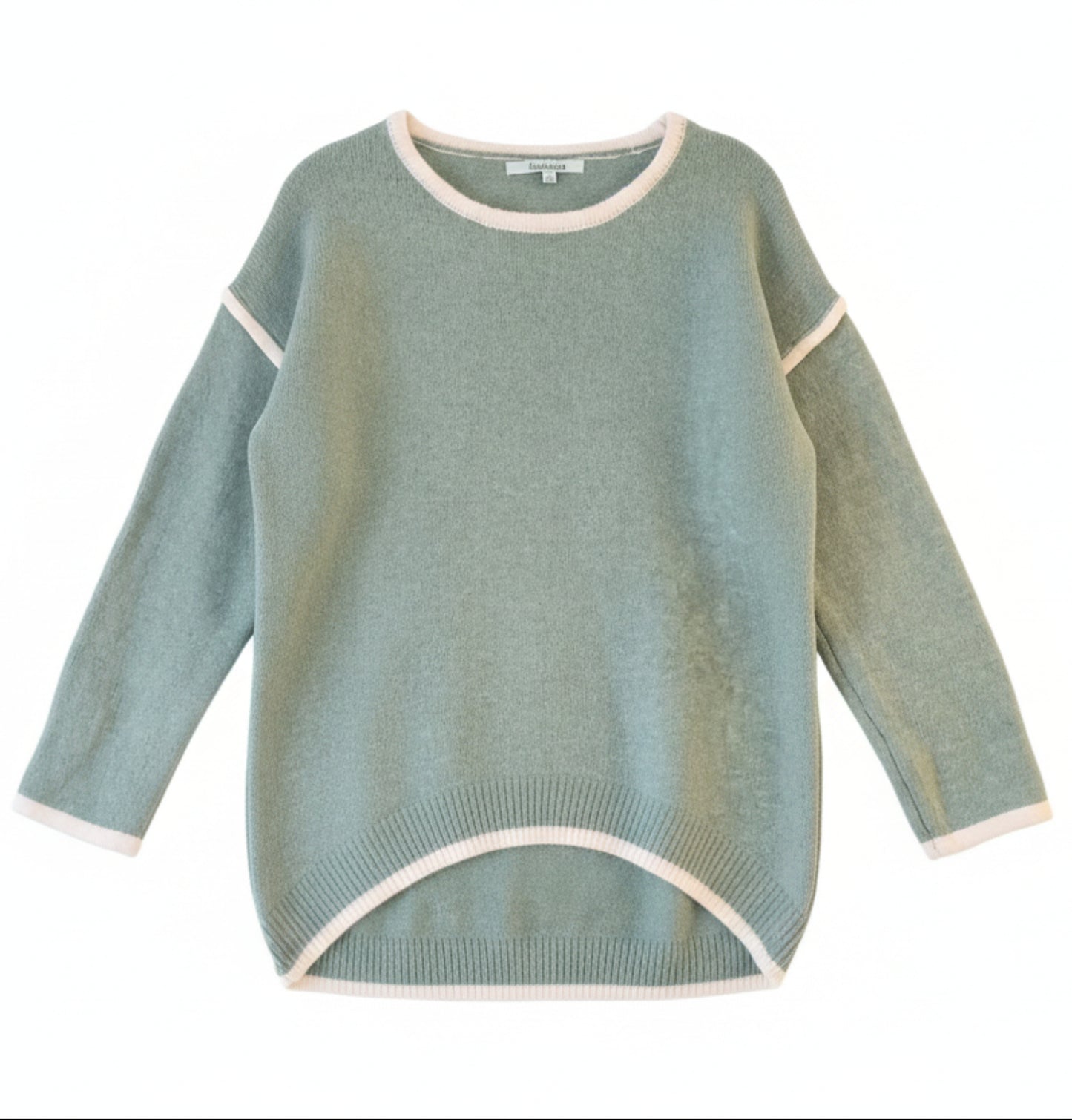 Green sweater with white trim on a wooden surface