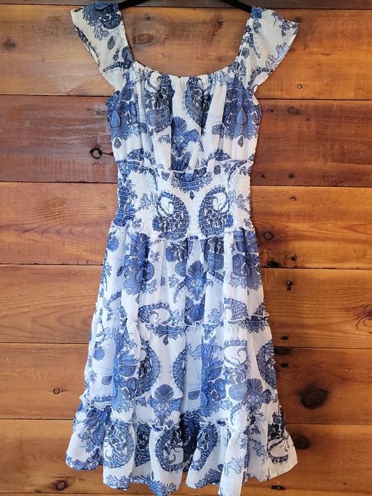 Blue and white floral dress on a wooden surface