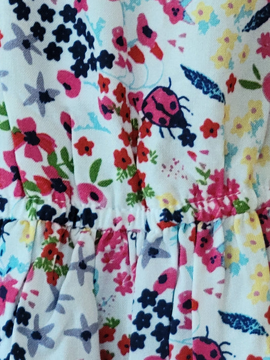 Floral fabric with ladybug pattern on a white background