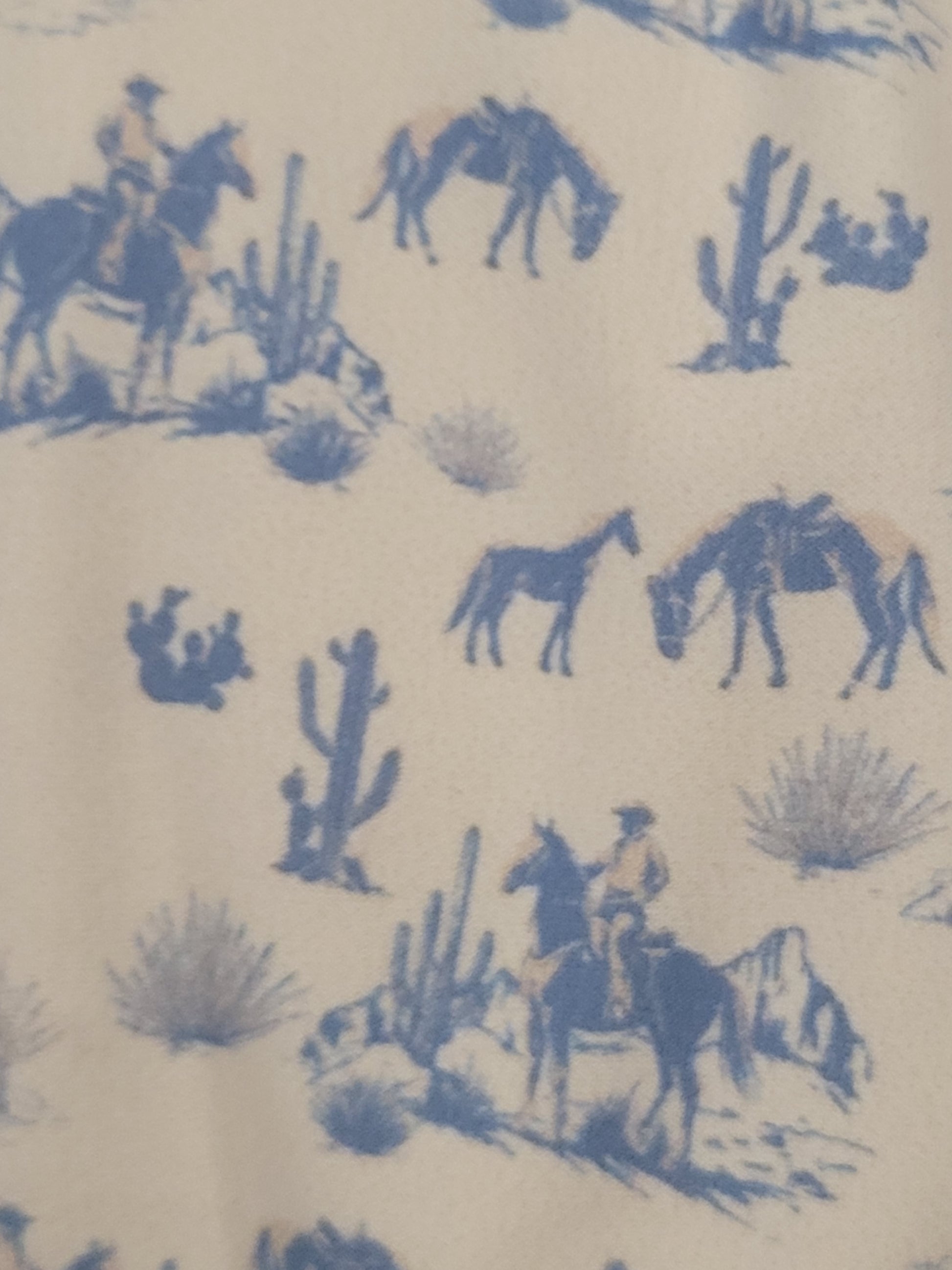 Patterned fabric with blue animal illustrations on a beige background