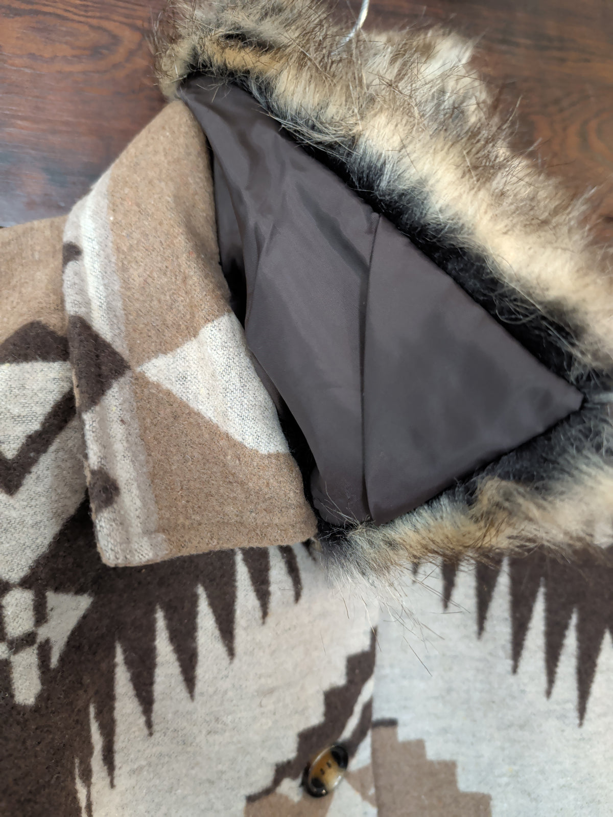 Coat neckline showing the faux fur collar folded back to reveal the fabric collar and dark lining and the removable collar.