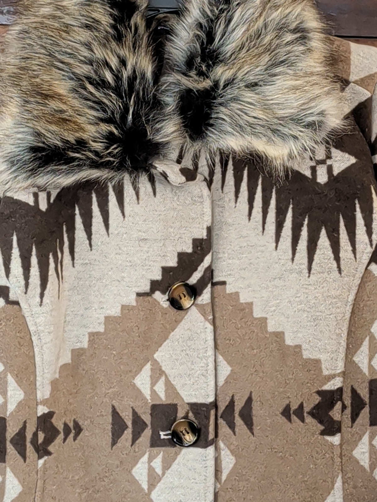 Close-up of the removable faux fur collar and upper button front on the Southwestern print coat.
