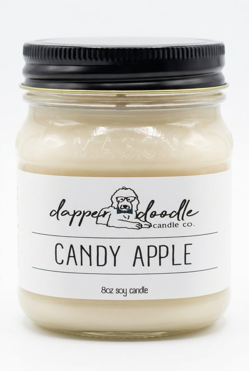 Dapper Doodle Candy Apple 8 oz. soy candle in a clear glass jar with a black lid and white label
