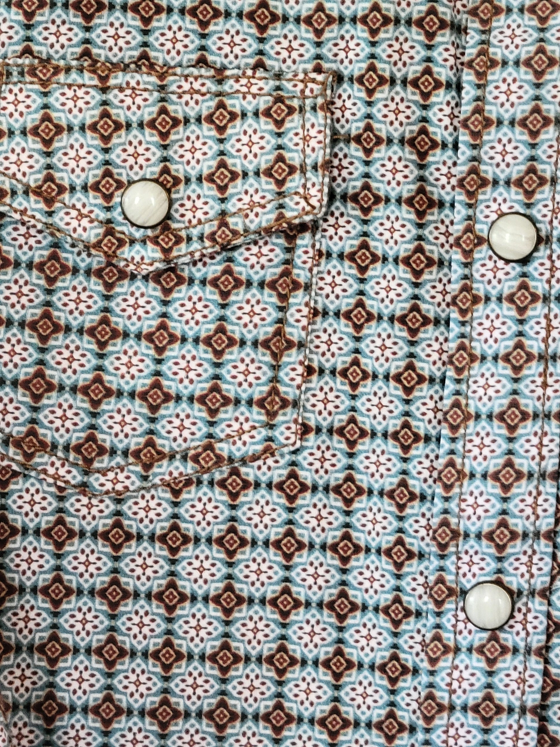 Patterned fabric with a geometric design featuring brown, white, and blue colors.