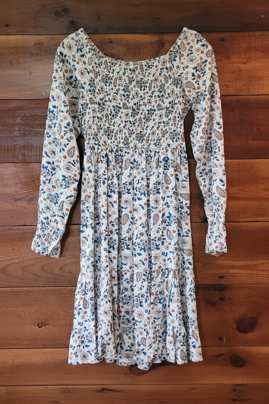 Floral patterned dress on a wooden surface