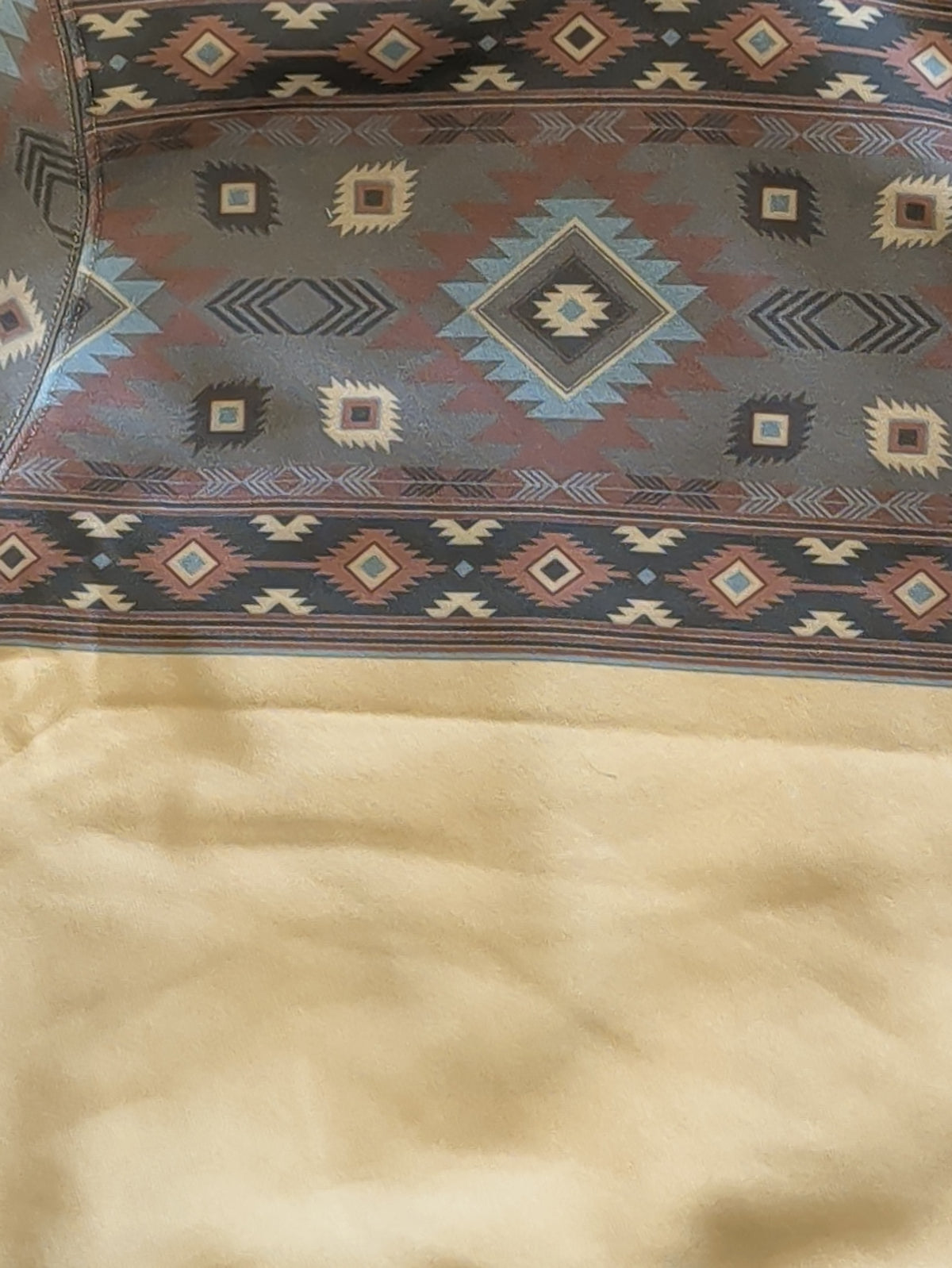 Close-up of the hoodie’s Southwestern print back yoke with blue, mauve, and cream geometric motifs above the cream fleece body