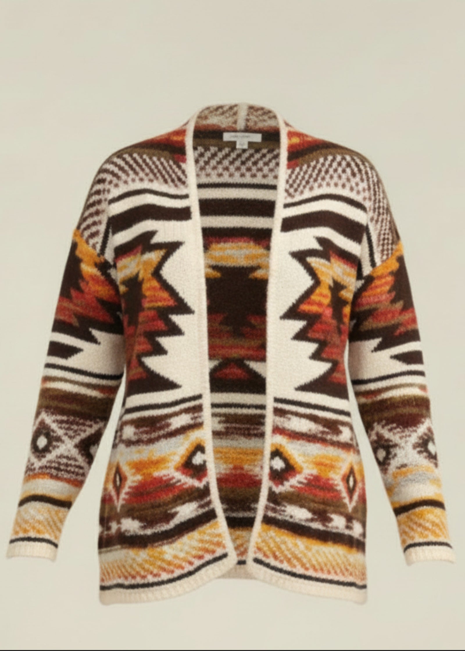 Woman wearing a patterned cardigan with a neutral background