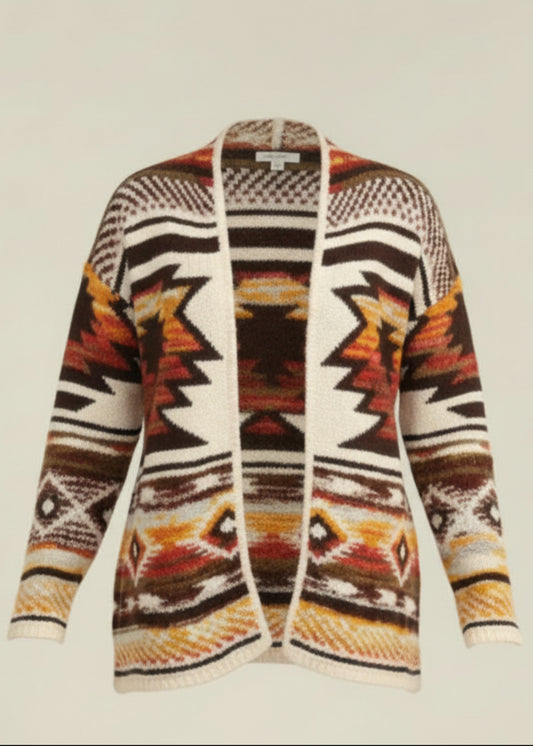 Woman wearing a patterned cardigan with a neutral background