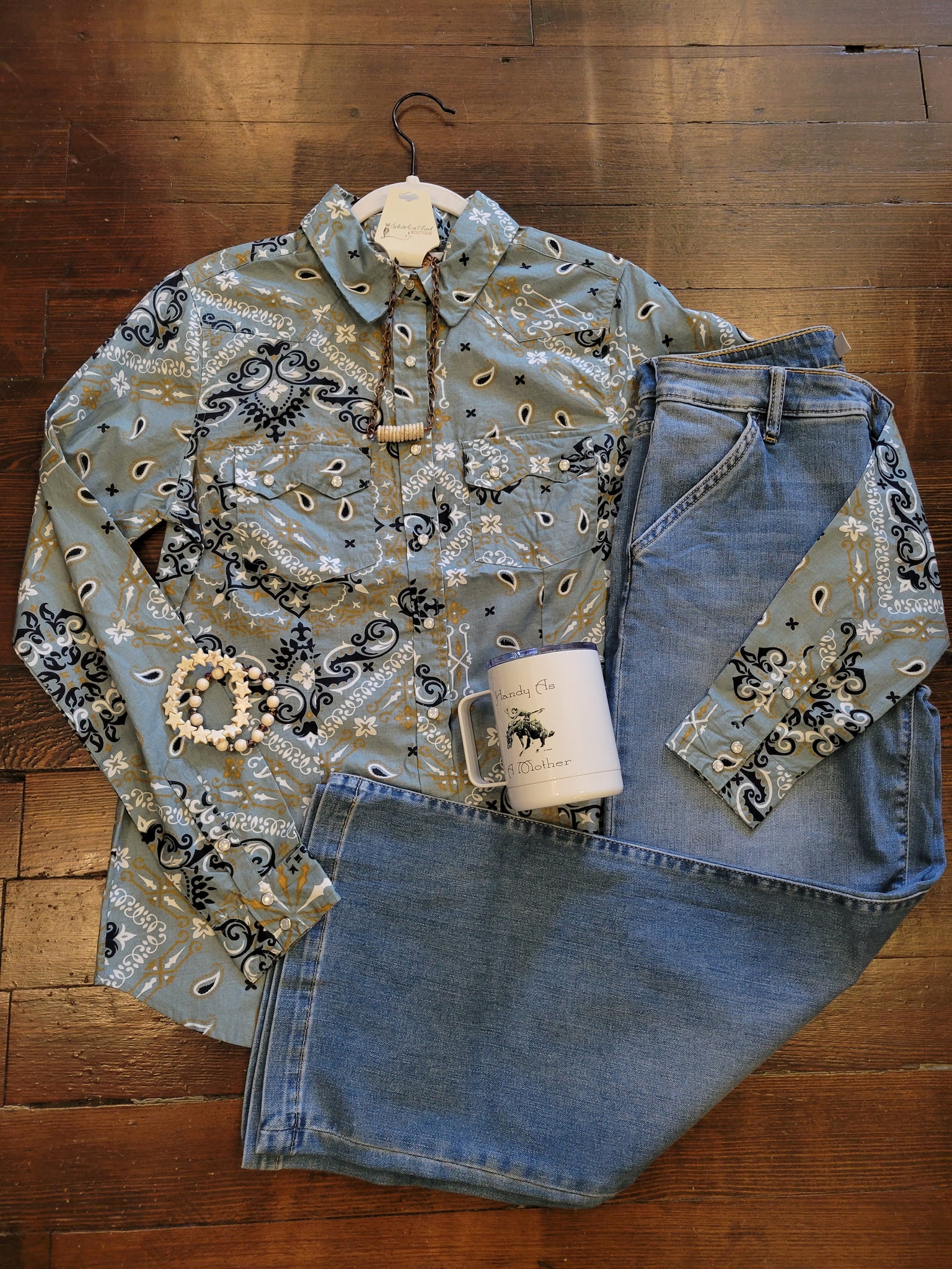Bandana pattern on a western snap shirt paired with jeans and a coffee mug