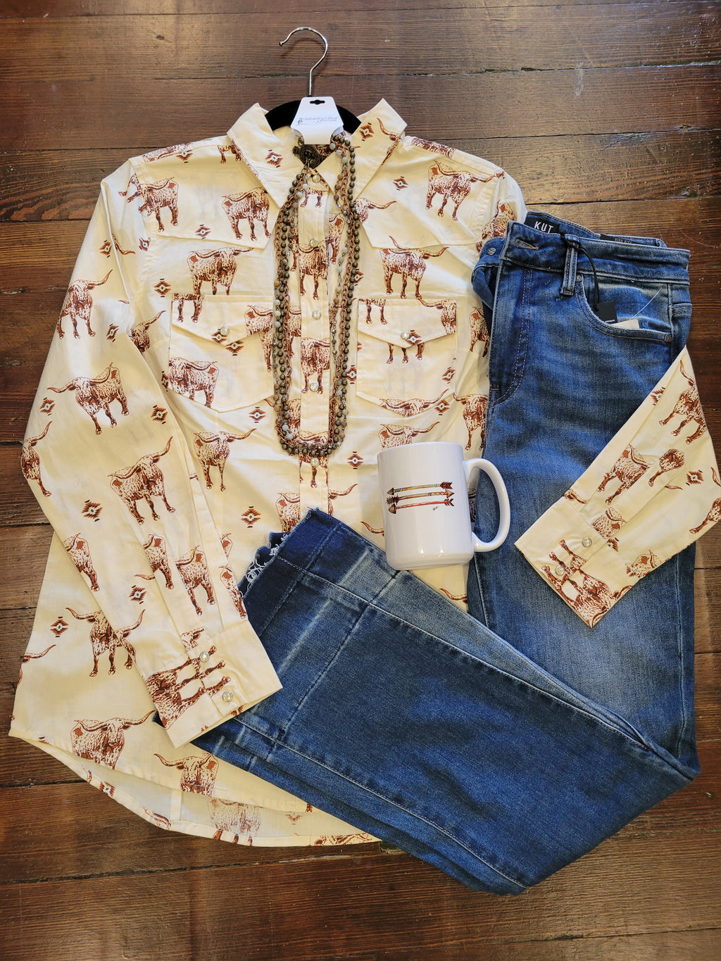 Longhorn shirt paired with denim and a arrows coffee mug